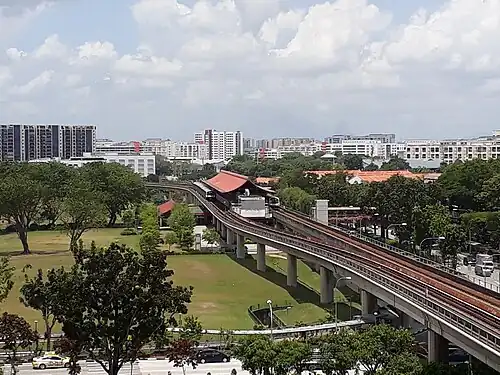 A bird's eye shot of Chinese Garden MRT station, which includes its Chinese-style roof and two trains in the station