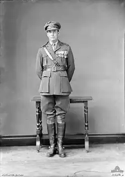Full-length portrait of man in military uniform wearing medals