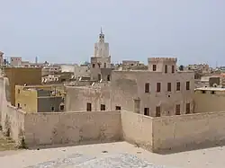 A panoramic view of a large city, largely coloured beige.