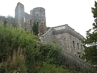 photo of steps leading to terrace with three storey ruins of round tower behind