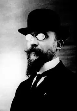 Satie wearing a bowler hat and wing collar