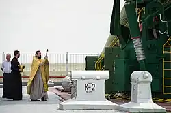 An Orthodox priest blesses the Soyuz rocket on 14 May 2012.