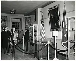 black and white image the Hoover desk on display behind a velvet rope