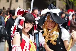 Two Cosplayers featuring Reimu Hakurei and Marisa Kirisame
