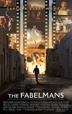 Against a collage of film strips depicting people in various scenes, a silhouetted figure walks between studio buildings toward a bright light. A tagline in yellow capital letters at the top of the poster reads "CAPTURE EVERY MOMENT". The title, "THE FABELMANS", appears in white near the bottom of the poster, with credits below it