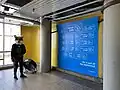 Photo area in Scarborough Centre Station with a blue backdrop reading "Farewell Line 3" in various languages, as well as social media handles for Meta-owned social websites and the hashtag #TakeTheTTC