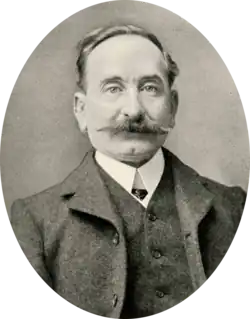 Portrait photograph of Fernando Tarrida, wearing a suit and a moustache, with receding hair