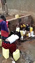 People in Uganda filling up water canisters (here around 5-20&nbsp;L).