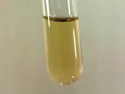 Small sample of pale yellow liquid fluorine condensed in liquid nitrogen