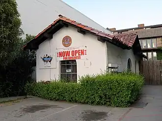 A white stucco building with a tile roof
