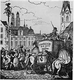 A population celebrates while soldiers escort secured wagon of material through the city. A pair of twin spires tower above the city, indicating the city is Zurich, Switzerland.