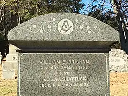 A late-19th-century headstone adorned with the Masonic square and compass