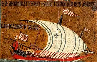 A one-masted bright red galley with its oared raised and a large lateen sail set, billowing in the wind.