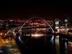 Picture of Gateshead Millennium Bridge at night. The construction of Gateshead Millennium Bridge formed part of wider regeneration projects in both Newcastle (pictured left) and Gateshead (pictured right).