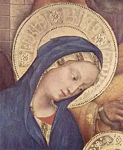 Pseudo-Arabic script in the Virgin Mary's halo, detail of Adoration of the Magi (1423) by Gentile da Fabriano. The script is further divided by rosettes like those on Mamluk dishes.[21]