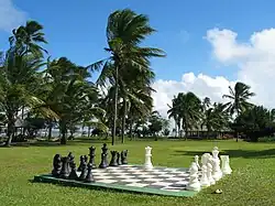 A giant outdoor chessboard, with pieces about three feet (91&nbsp;cm) tall