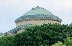 The dome of the Gould Memorial Library can be seen above the trees from many locations in Upper Manhattan