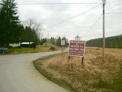 Sign for the churches of Grover, Pennsylvania as seen at a turn from State Route&nbsp;154 in February&nbsp;2012
