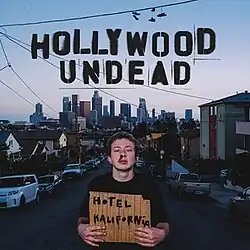 A man with a bloody nose holds up a sign that says "Hotel Kalifornia". Above him is the Hollywood Undead logo.