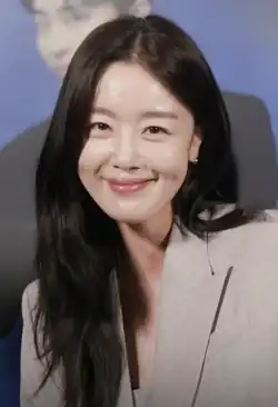 Han looking at the camera and smiling while promoting her movie "Pilot".