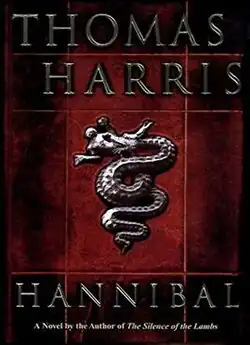 Artwork of a vertical, rectangular box. The text and illustration look like they were chiseled out of silver. The background consist of red tiles shaded with different levels of black. On top, there is the author's name, Thomas Harris. Below, in the middle, there is the illustration of a Biscione a symbol which features on the coat-of-arms of the Visconti and Sforza families of which the title character is meant to be a descendant, styled as an ancient bas-relief. On the bottom, there is the title, Hannibal. Below the title there is a sentence that says, "A Novel by the Author of The Silence of the Lambs"
