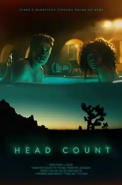 Poster for the horror film Head Count. The top half of the image shows a young man and woman in a hot tub, looking tense and concerned, illuminated by dim, eerie lighting. The bottom half depicts a desert landscape at twilight, featuring a silhouetted Joshua tree and a lone figure standing in the distance. The title is written in glowing neon blue letters. A tagline at the top reads, "There's something strange going on here", and the film's selection at the LA Film Festival 2018 is highlighted.
