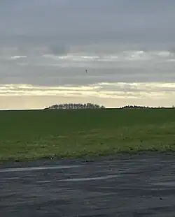 T-Shaped object situated above the airfield runway.