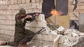 An IRPGF fighter firing at enemy positions in Tabqa