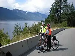Cyclists on the International Selkirk Loop near Kootenay Lake, British Columbia