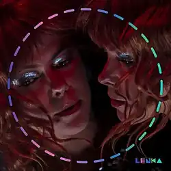 A woman whose glittery-eyed face is reflected in a mirror, with a colorful dotted circle and the name "Lenka" in the corner.