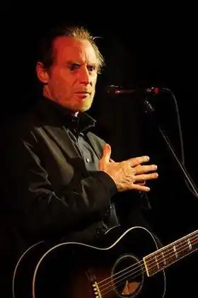 JD Souther holding a guitar, performing live at age 63