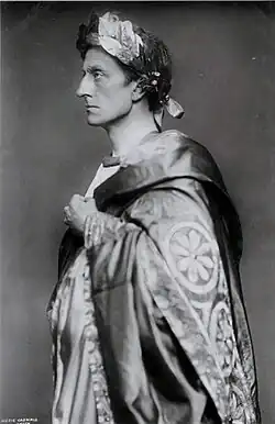 Middle-aged, clean shaven white man with a determined gaze shown in profile from the waist up, wearing Roman toga and laurel wreath