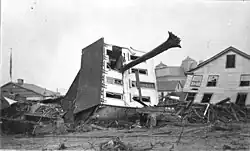 The John Schultz house in Johnstown, Pennsylvania after the flood. Skewered by a huge tree uprooted by the flood, the house floated down from its location on Union Street to the end of Main. Six people, including Schultz, were inside the house when the flood hit; all survived.
