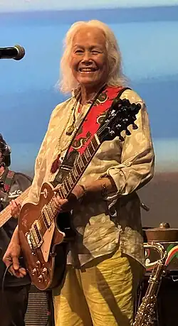 June Millington playing a guitar