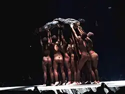 West carried by semi-naked women at the Staples Center for the Yeezus Tour