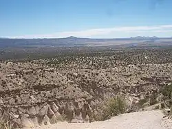 Tent rocks, with Cochiti Pueblo lands and the Rio Grande in the distance