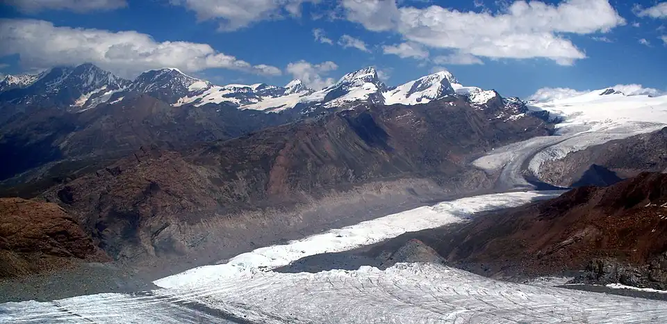 2007: The loss of thickness (about 200 m (660 ft)) of the lower Gorner Glacier since its major expansion in 1859 is recognizable on the south flank of the Gornergrat by the leftover and much higher lateral moraine (the light-coloured part above the grey flank); as seen from the Klein Matterhorn.