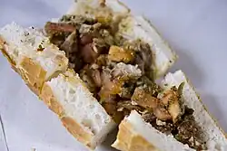 Kokoretsi with tomatoes and spices, served on bread in Eminönü