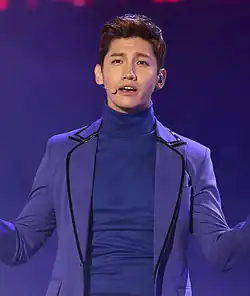 24-year-old Korean man with a microphone and purple clothing