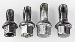 Four lug bolts, from left: Three M12x1.5&nbsp;mm bolts with different length and one M14x1.5&nbsp;mm bolt