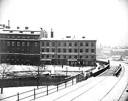 Bridge crossing river and two buildings on the other side of the river