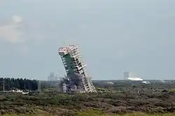 The MSS of Launch Complex 36A falls to the ground after critical supports are destroyed in a controlled explosion.