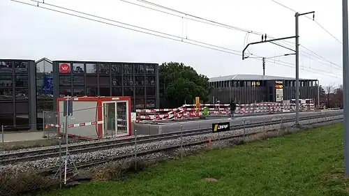 Single-track railway with a station platform and shelter