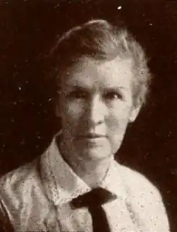 An older white woman with grey hair in an updo