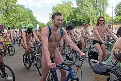 A large number of nude and semi-nude cyclists