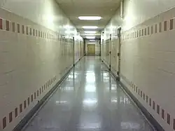 An example of a liminal space. This is an image of a long, empty hallway.
