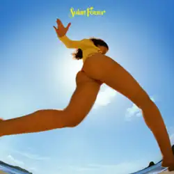 A distorted lens looks up at Lorde's bare legs and buttocks as she runs on the beach wearing a yellow sweater and barely visible thong.