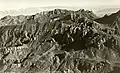 1937 aerial view of Lost Mine Peak centered at top, from WNW.