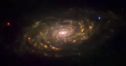 Messier 63 seen in the infrared by the Spitzer Space Telescope. The infrared radiation traces the dust within the spiral arms, which does not radiate visible light. A small dust ring can be seen just outside of the galaxy's center.[21]