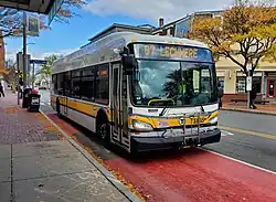 A bus on a red bus lane in an urban square